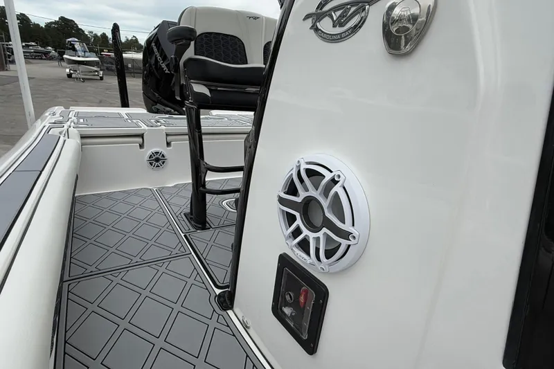 Slide: The Image of 2024 Tidewater 2500 Carolina Bay boat interior with speaker and seating detail. - 7