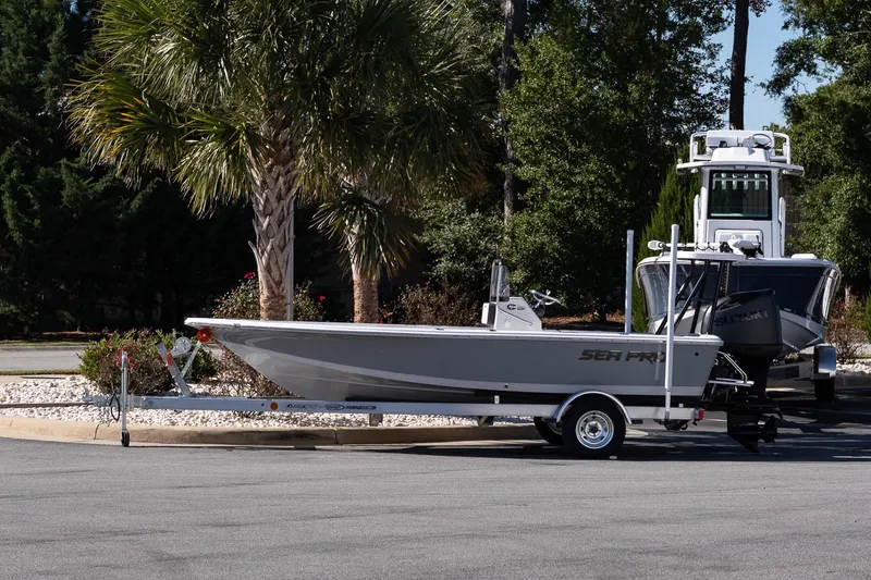 The Image of 2026 Sea Pro 172 Bay boat on trailer, parked near palm trees. - 1