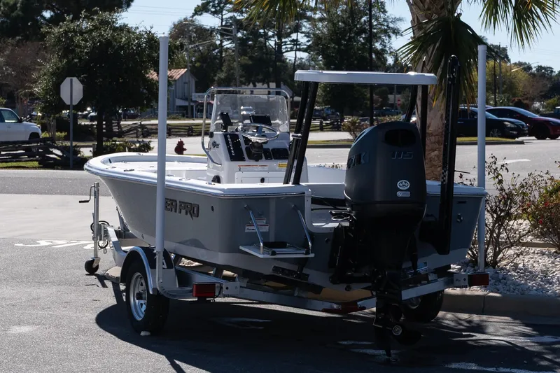 Slide: The Image of 2026 Sea Pro 172 Bay boat on trailer, parked outdoors in a sunny setting. - 5
