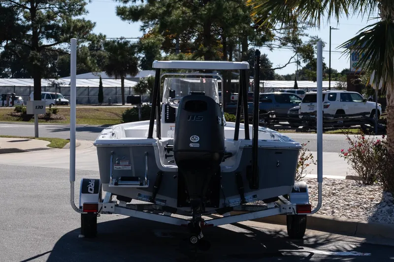 Slide: The Image of 2026 Sea Pro 172 Bay boat on trailer, parked outdoors with trees in the background. - 6