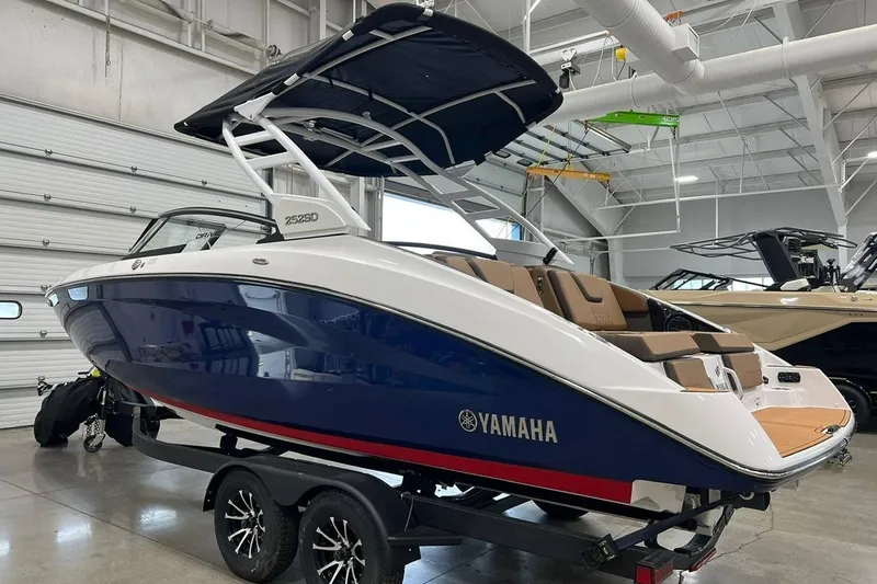 Slide: The Image of 2025 Yamaha Boats 252SD in showroom, featuring sleek design and modern amenities. - 2