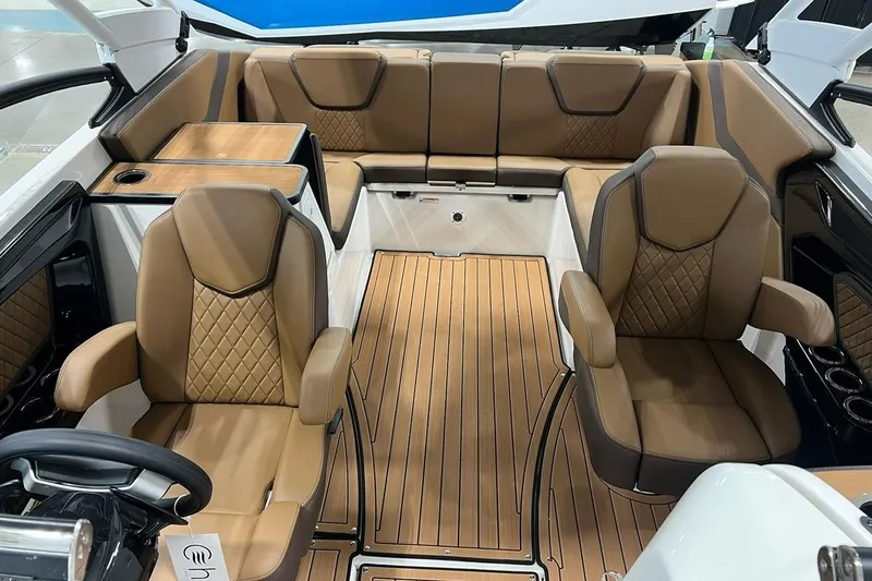 Slide: The Image of Luxurious interior of 2025 Yamaha Boats 252SD with tan leather seating and wood flooring. - 4