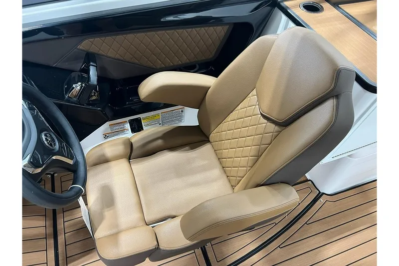 Slide: The Image of Luxurious tan captain's seat in 2025 Yamaha Boats 252SD, featuring diamond stitching and ergonomic design. - 8