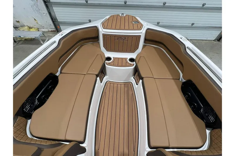Slide: The Image of 2025 Yamaha Boats 252SD interior with tan seating and wood accents. - 9