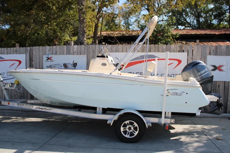 The Image of 2026 Scout 188 Sportfish boat on trailer, parked outdoors. - 1
