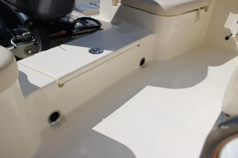 Slide: The Image of Interior view of 2026 Scout 188 Sportfish boat, showcasing seating and engine area. - 13
