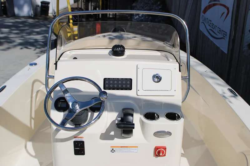 Slide: The Image of 2026 Scout 188 Sportfish boat dashboard with steering wheel and controls. - 14