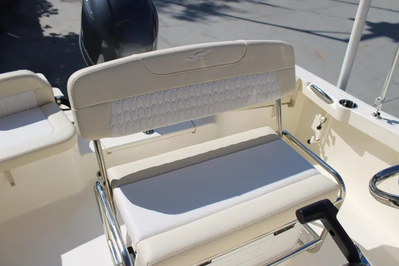 Slide: The Image of 2026 Scout 188 Sportfish boat interior with cushioned seating and steering wheel. - 16