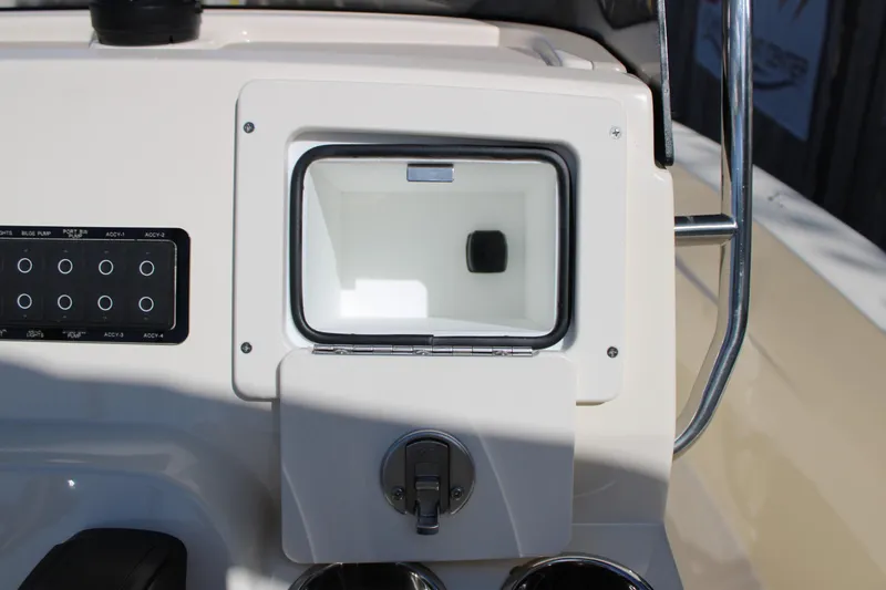 Slide: The Image of 2026 Scout 188 Sportfish console with storage compartment and control panel. - 18