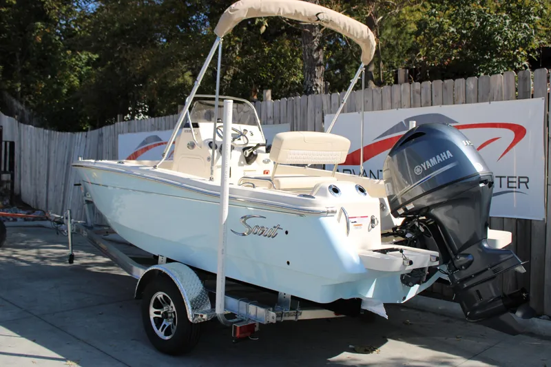 Slide: The Image of 2026 Scout 188 Sportfish boat with Yamaha engine on trailer, outdoor display. - 3