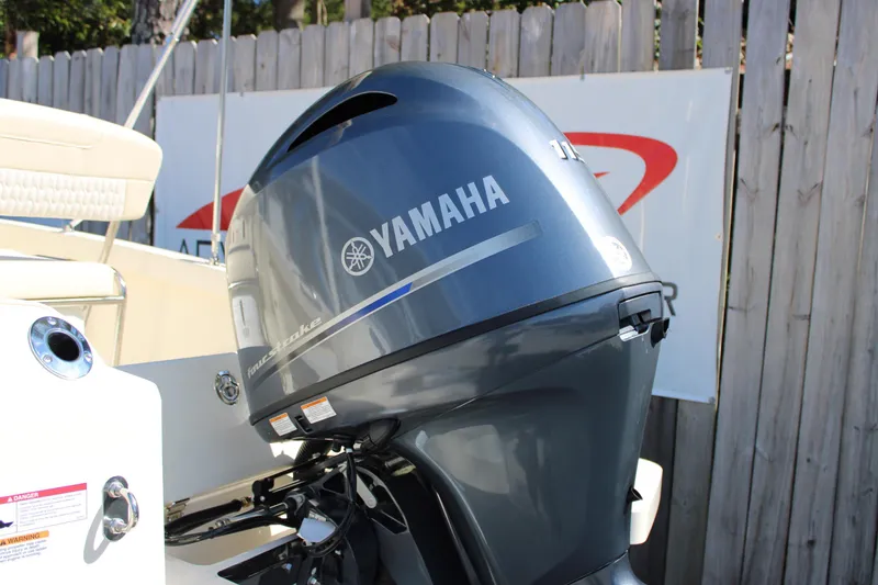Slide: The Image of 2026 Scout 188 Sportfish with Yamaha outboard motor, displayed outdoors. - 5