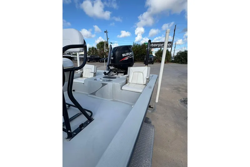 Slide: The Image of 2016 BLUEWAVE 2200 boat with Suzuki engine, parked outdoors under blue sky. - 10