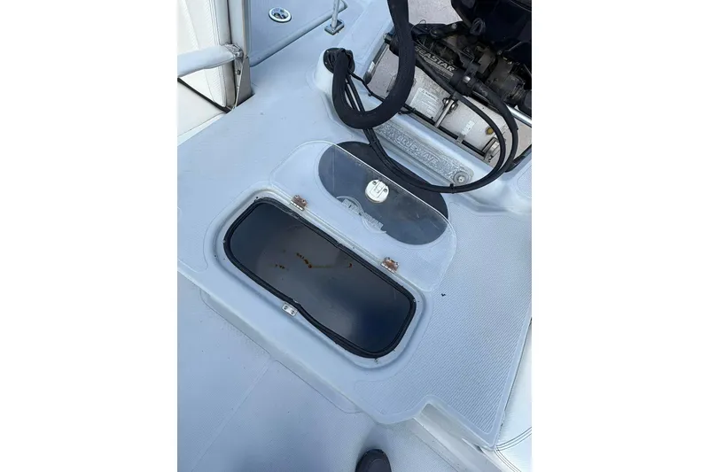 Slide: The Image of 2016 BLUEWAVE 2200 boat deck with storage compartment and engine components visible. - 11
