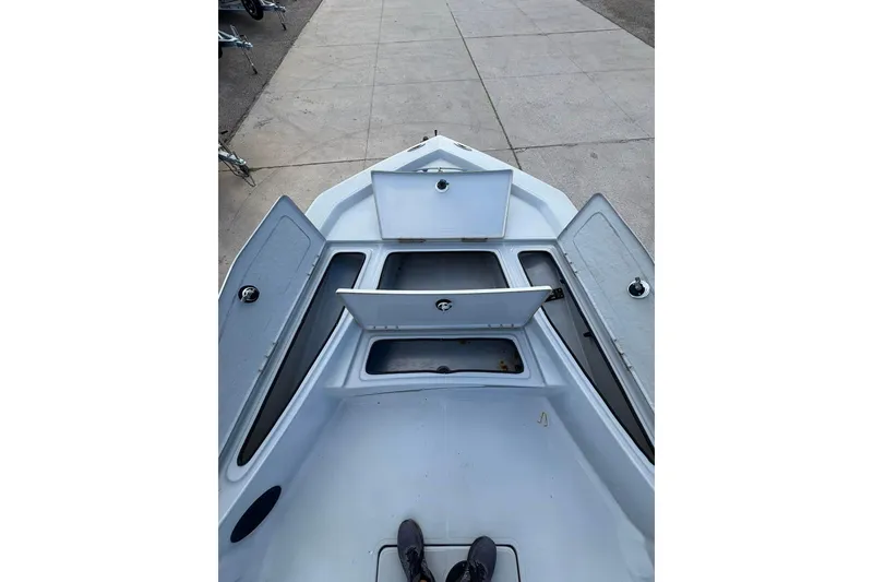 Slide: The Image of 2016 BLUEWAVE 2200 boat interior with open storage compartments on deck. - 5