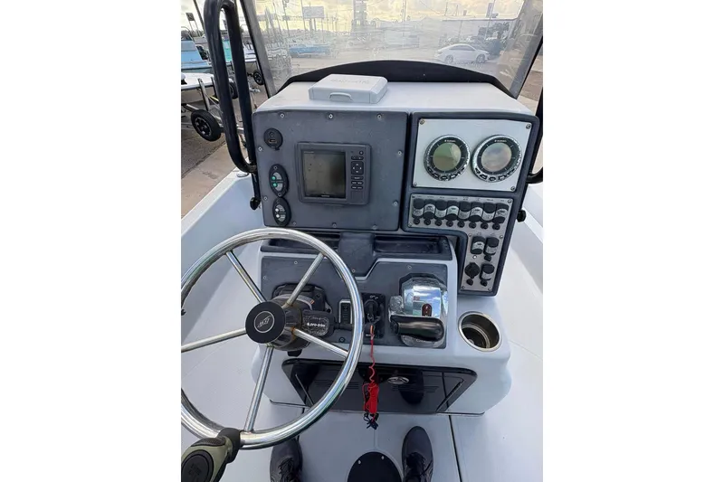 Slide: The Image of 2016 BLUEWAVE 2200 boat dashboard with steering wheel and control panel. - 8