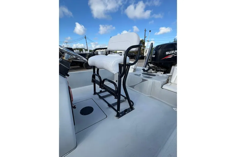 Slide: The Image of 2016 BLUEWAVE 2200 boat interior with white seating and Suzuki outboard motor. - 9