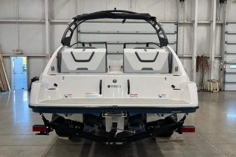 Slide: The Image of 2025 Yamaha Boats AR220 in a showroom, rear view showcasing sleek design and features. - 3