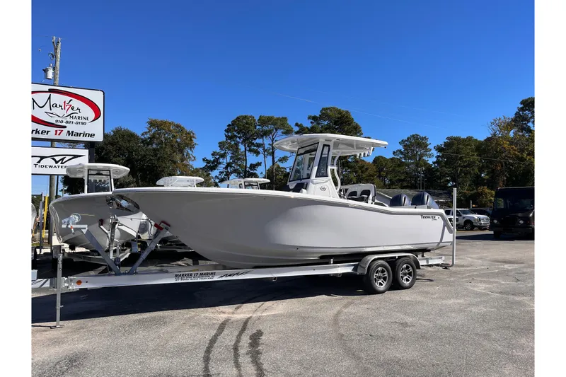 Slide: The Image of 2026 Tidewater 256 LXF boat on trailer at Marker 17 Marine dealership. - 1