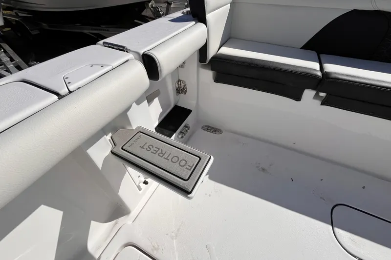 Slide: The Image of 2026 Tidewater 256 LXF boat interior with cushioned seating and footrest. - 11