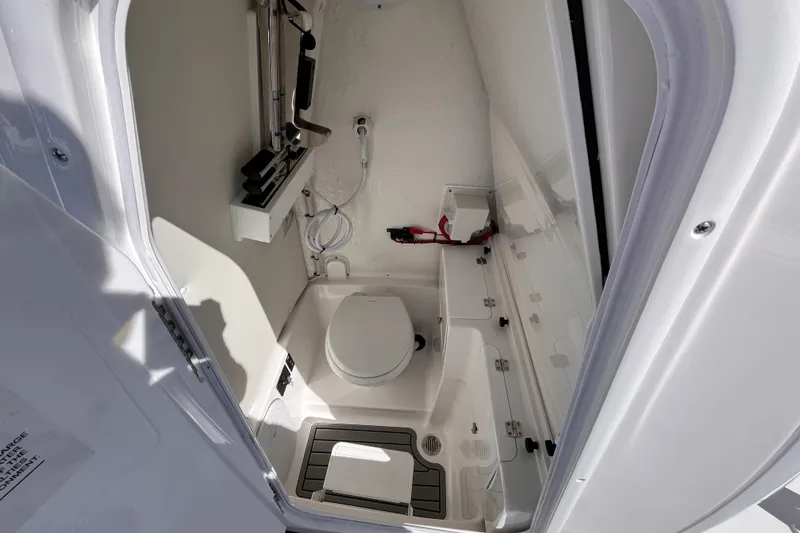 Slide: The Image of 2026 Tidewater 256 LXF boat interior bathroom with toilet and storage. - 17