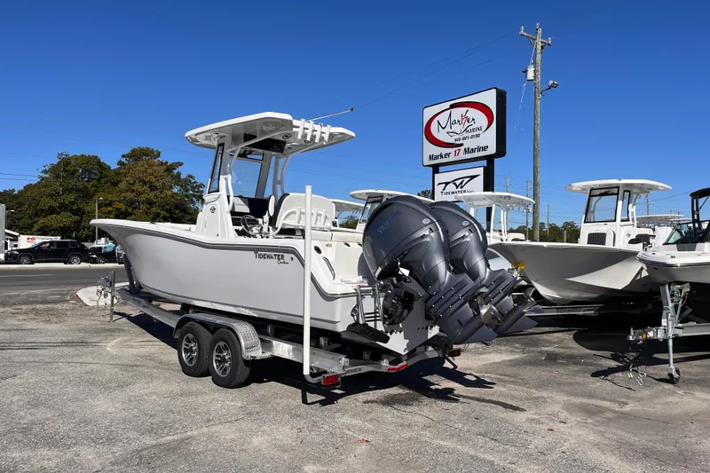 Slide: The Image of 2026 Tidewater 256 LXF boat on trailer at Marker 17 Marine dealership. - 3