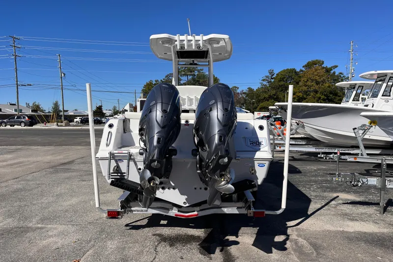 Slide: The Image of 2026 Tidewater 256 LXF boat with dual outboard motors, parked on a trailer. - 4