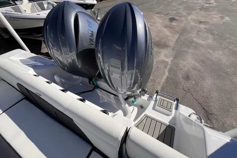 Slide: The Image of 2026 Tidewater 256 LXF boat with dual Yamaha outboard engines, docked on a sunny day. - 6
