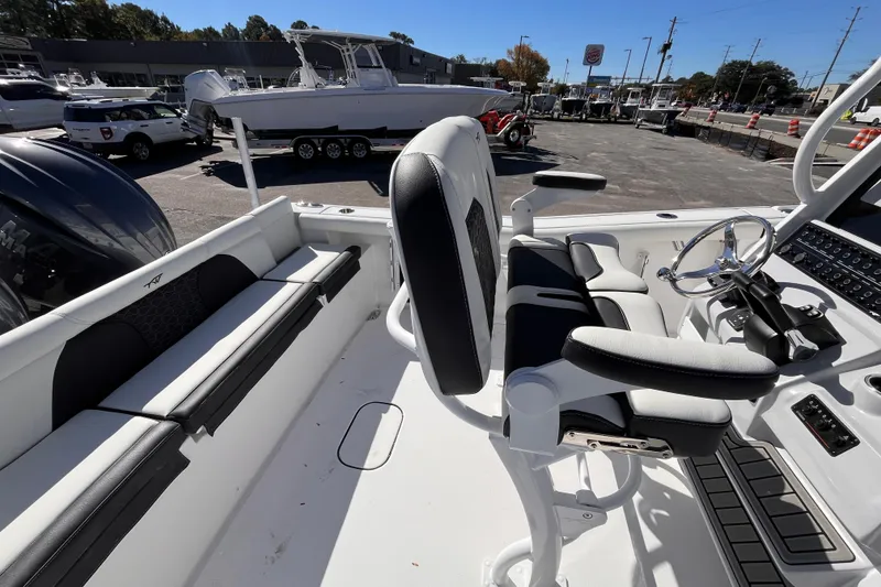 Slide: The Image of 2026 Tidewater 256 LXF boat interior with seating and control panel. - 8