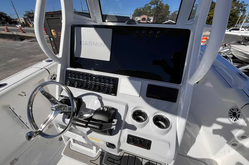 Slide: The Image of 2026 Tidewater 256 LXF boat console with Garmin display and steering wheel. - 9