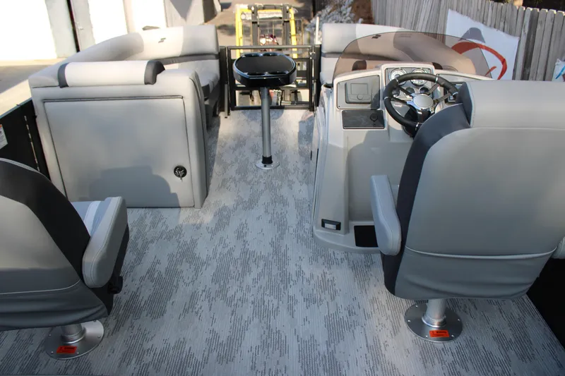 Slide: The Image of 2026 Starcraft EXS 1 Q DH boat interior with modern seating and steering console. - 10