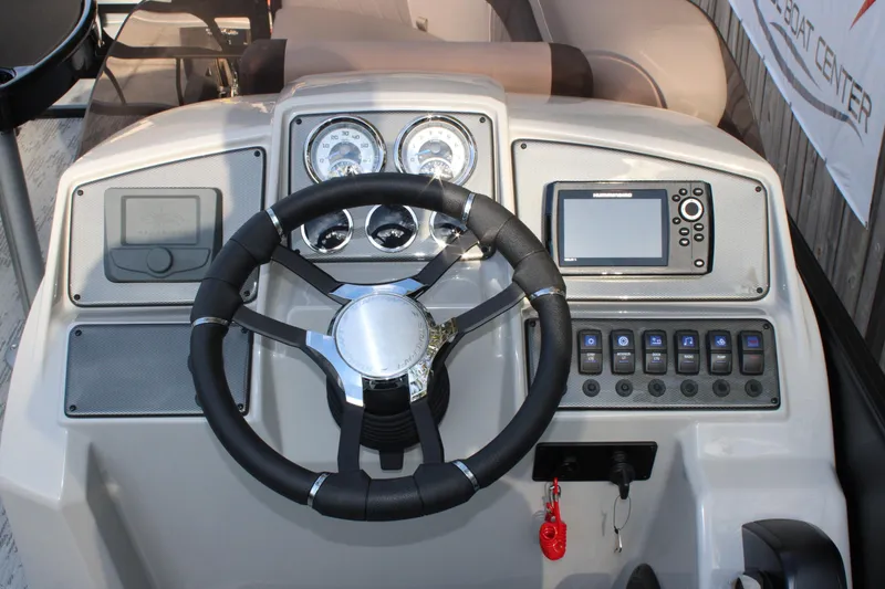 Slide: The Image of Steering console of 2026 Starcraft EXS 1 Q DH boat with gauges and controls. - 11