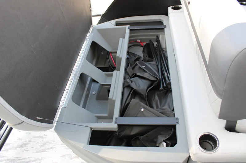 Slide: The Image of 2026 Starcraft EXS 1 Q DH boat storage compartment with open lid and stored items. - 28