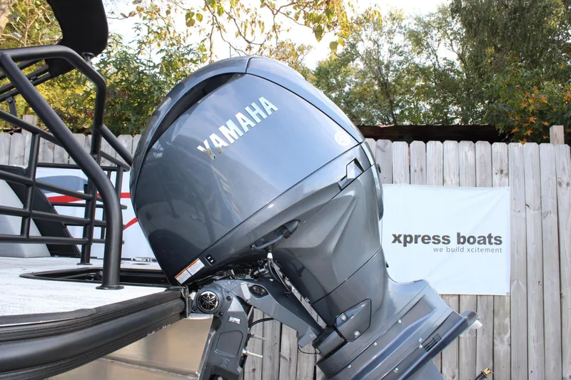 Slide: The Image of Yamaha outboard motor on Starcraft EXS 1 Q DH 2026 boat, near wooden fence. - 4