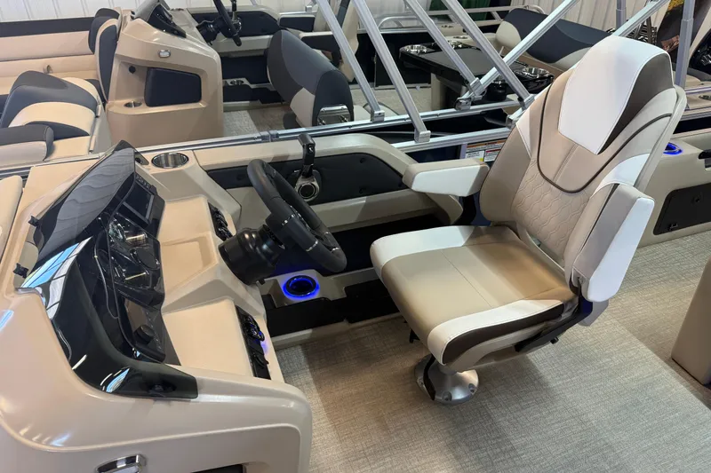 Slide: The Image of 2026 Tahoe Pontoon LTZ Quad Lounger Shift interior with captain's chair and steering console. - 4