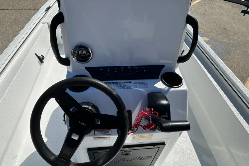 Slide: The Image of Steering console of 2026 Avid 18 Rogue CC boat with controls and gauges. - 10