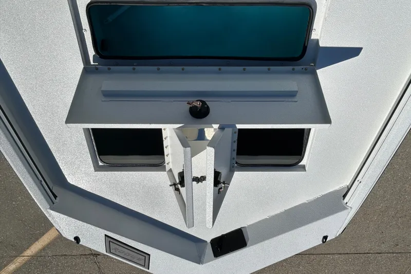 Slide: The Image of Avid 18 Rogue CC 2026 boat deck with open compartments and sleek design. - 14