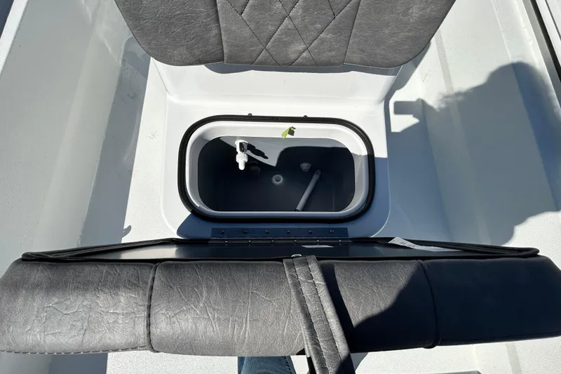 Slide: The Image of Avid 18 Rogue CC 2026 boat seat with storage compartment open. - 16