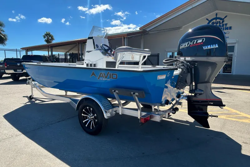 Slide: The Image of 2026 Avid 18 Rogue CC boat with Yamaha engine on trailer, parked outdoors. - 3