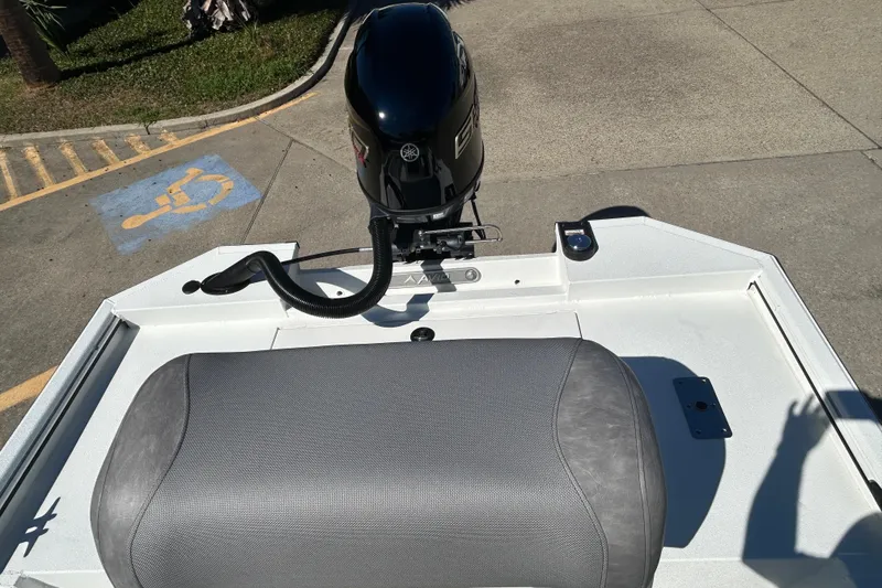 Slide: The Image of 2026 Avid 18 Rogue CC boat with outboard motor in parking area. - 8