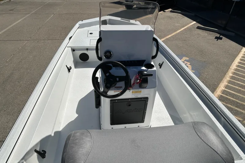 Slide: The Image of 2026 Avid 18 Rogue CC boat interior with steering console and seating. - 9