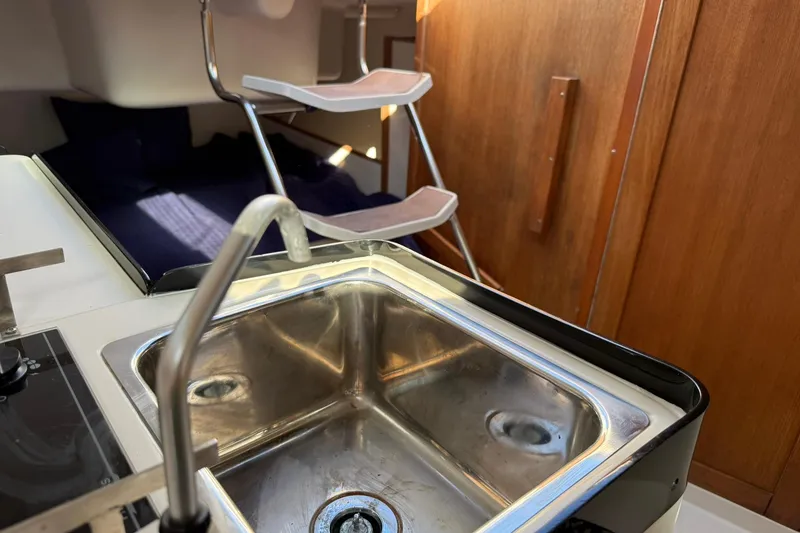Slide: The Image of Interior of 2000 Catalina 250 MkII sailboat showing kitchen sink and cabin area. - 10