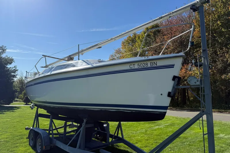 Slide: The Image of Catalina 250 MkII 2000 sailboat on trailer, parked on grass under clear blue sky. - 5