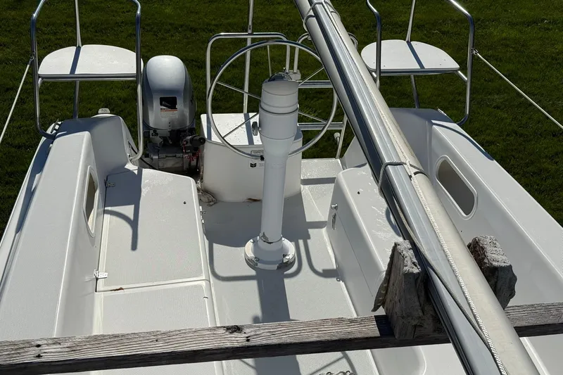 Slide: The Image of Cockpit of a 2000 Catalina 250 MkII sailboat with steering wheel and outboard motor. - 6