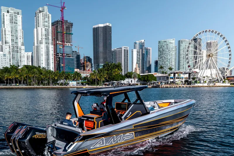 Slide: The Image of 2026 AMP 333 boat cruising near city skyline and Ferris wheel. - 10