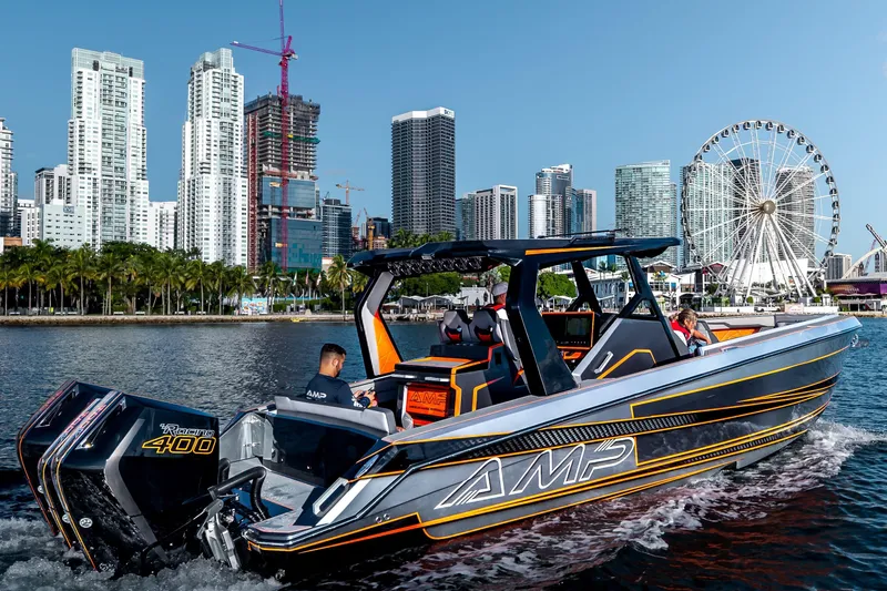 Slide: The Image of 2026 AMP 333 boat cruising near city skyline and Ferris wheel. - 11