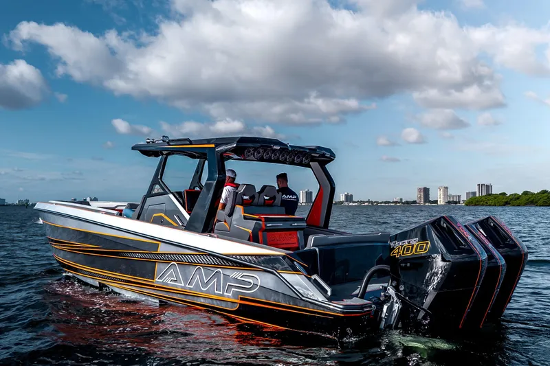 Slide: The Image of Modern AMP 333 boat cruising on water, featuring powerful engines, under a partly cloudy sky. - 14