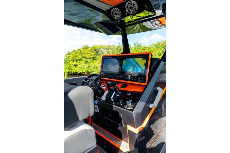 Slide: The Image of Futuristic AMP 333 boat dashboard with dual screens and modern controls, 2026 model. - 26