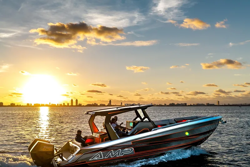 Slide: The Image of A sleek AMP 333 boat cruising at sunset, 2026 model, on a serene waterway. - 3