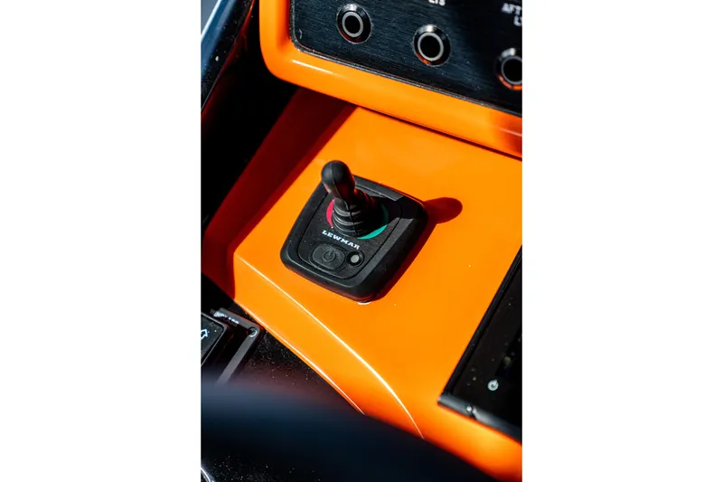 Slide: The Image of Orange control panel with joystick in AMP 333, 2026 model. - 31