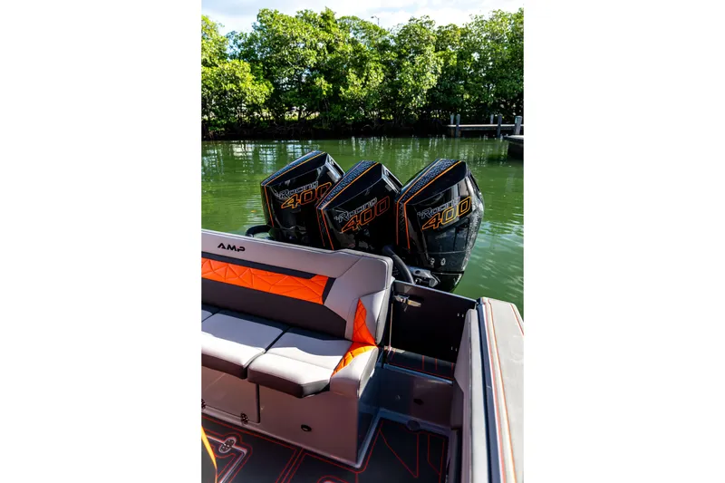 Slide: The Image of 2026 AMP 333 boat with triple Racing 400 engines, docked by lush greenery. - 32